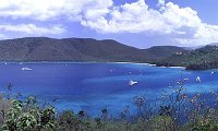Maho Bay Panorama  This is another view from Northshore Road on St. John in the US Virgin Islands. You are looking down on the turquoise blue waters of Maho and Francis Bay. The boats (should I say yachts?) are moored in the bay, dotting the water with their whiteness. The lighter colors in the water come from the depth -- shallower water shows the white sand on the bottom. Great snorkeling here too! Technically, I love this shot because I know what went into it. It really consists of 5 photos stitched together by hand in Photoshop. I'm amazed how well it turned out since I handheld the camera (a tripod is usually recommended for this technique). Try not to look too closely -- you may find a seam (I almost dare you!). I liked this picture so much, it is framed on the wall right behind me as I type this in!